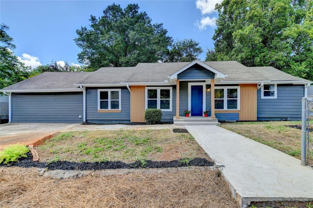 a front view of a house with a garden