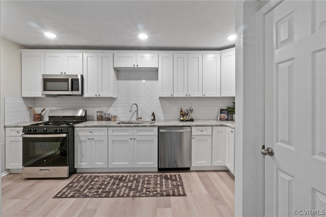 a kitchen with a sink stove and microwave