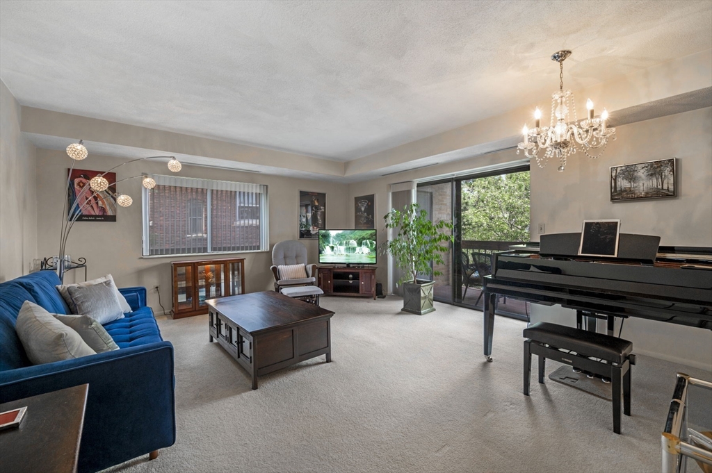 a living room with furniture and a chandelier