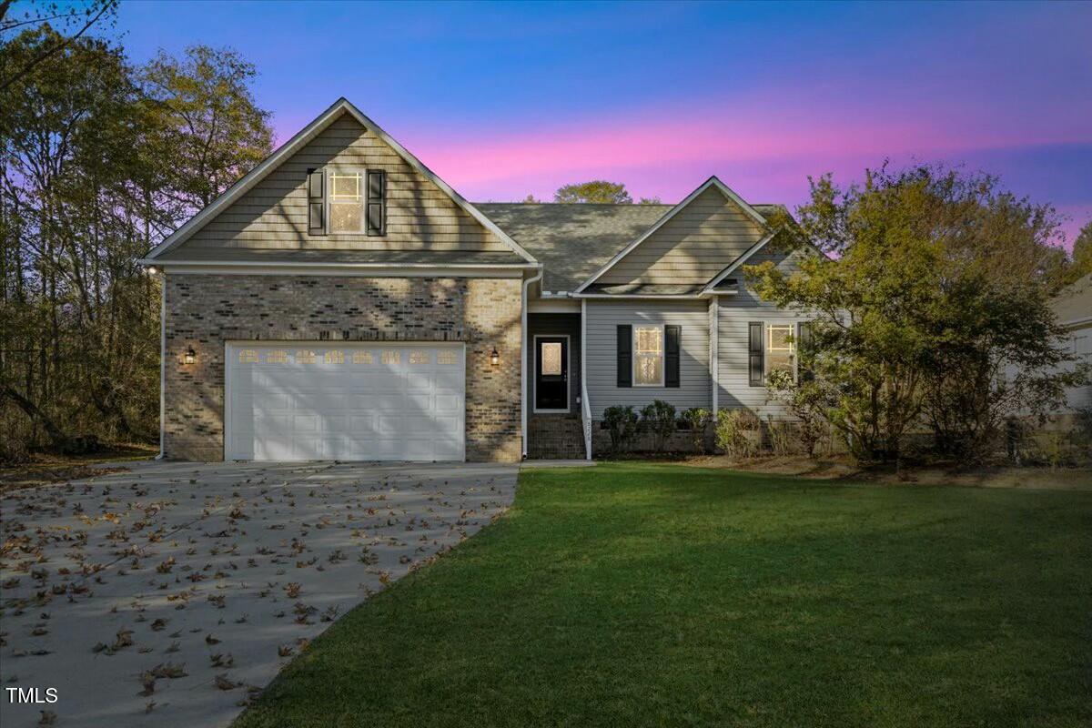 a front view of a house with a yard