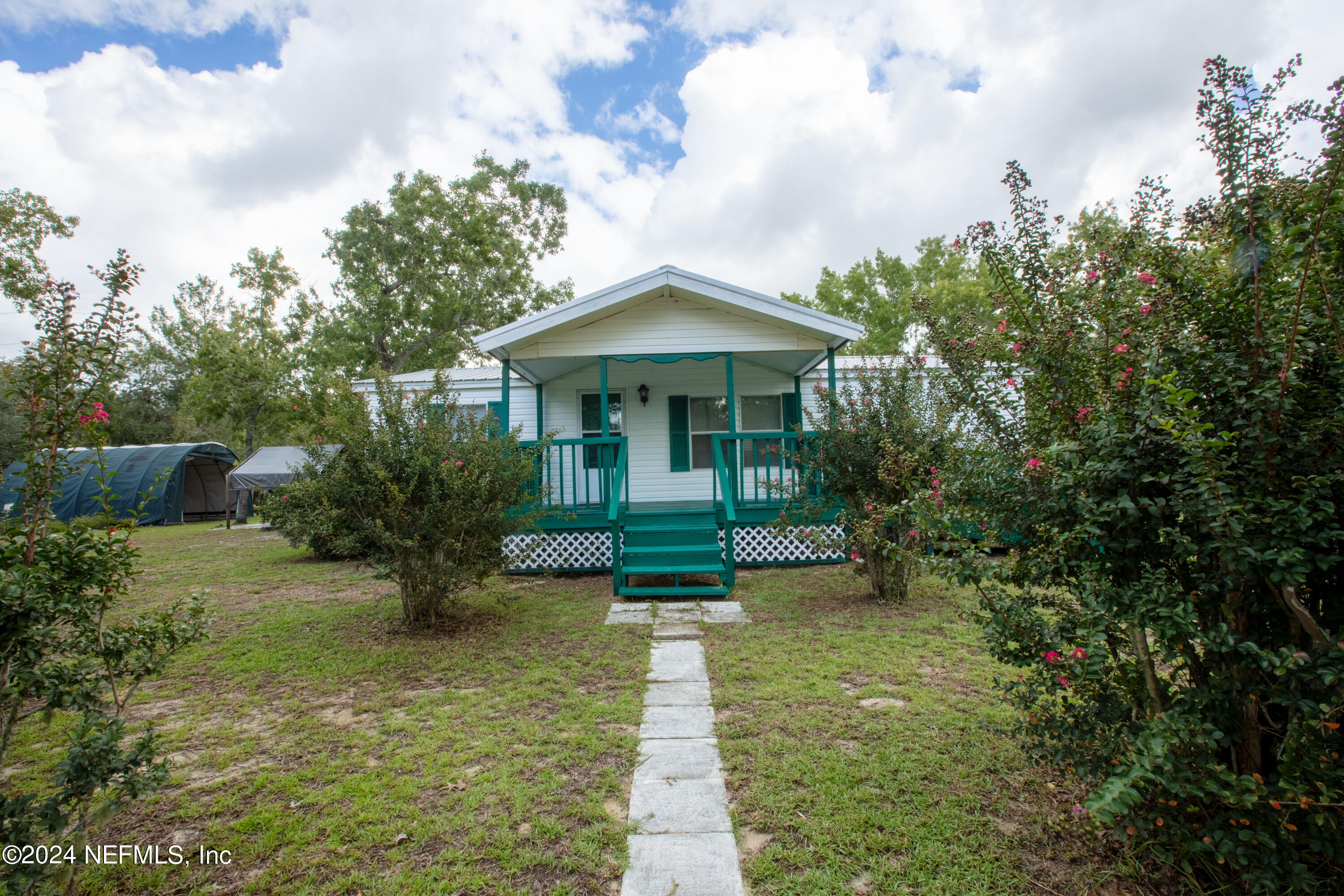 a front view of a house with garden