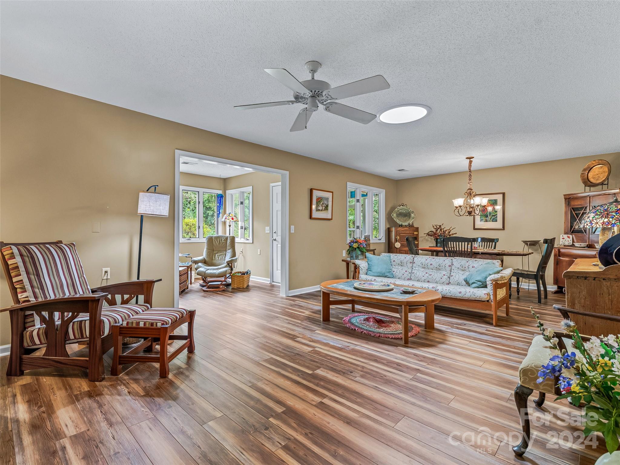 a living room with furniture and wooden floor