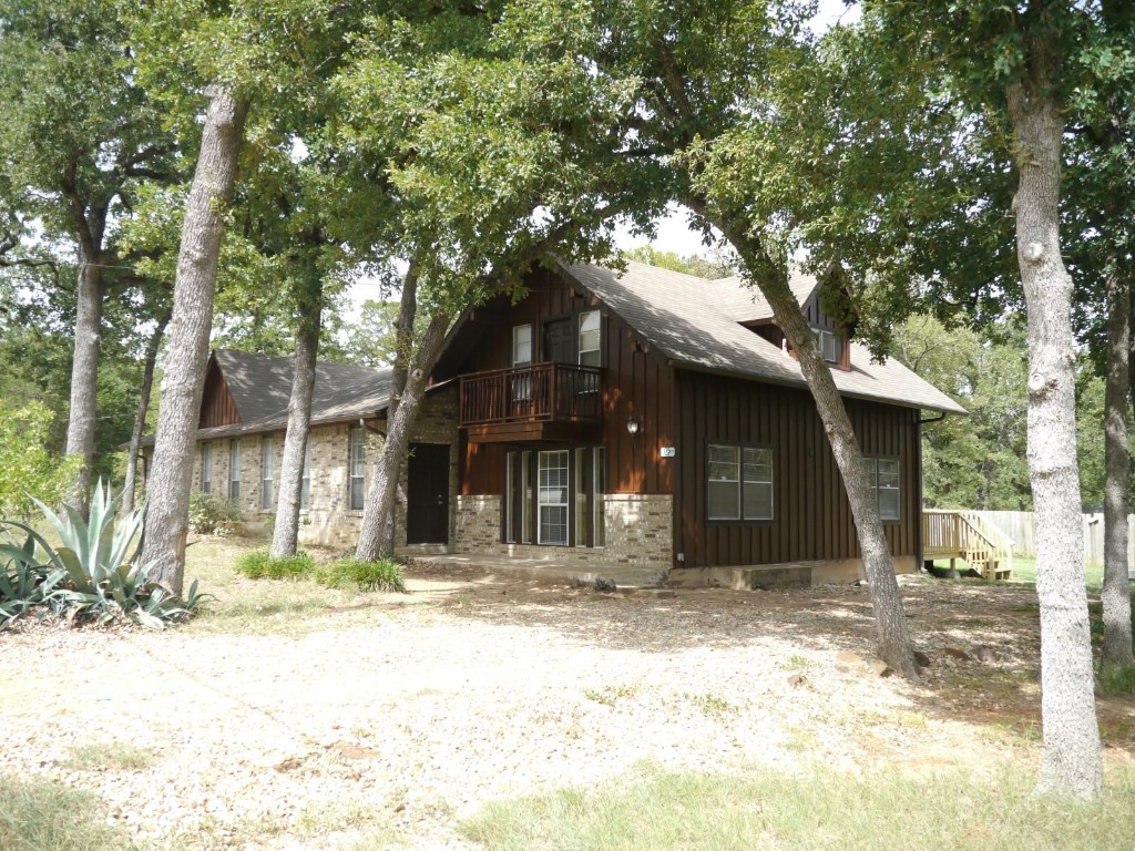 a house with trees in the front of it