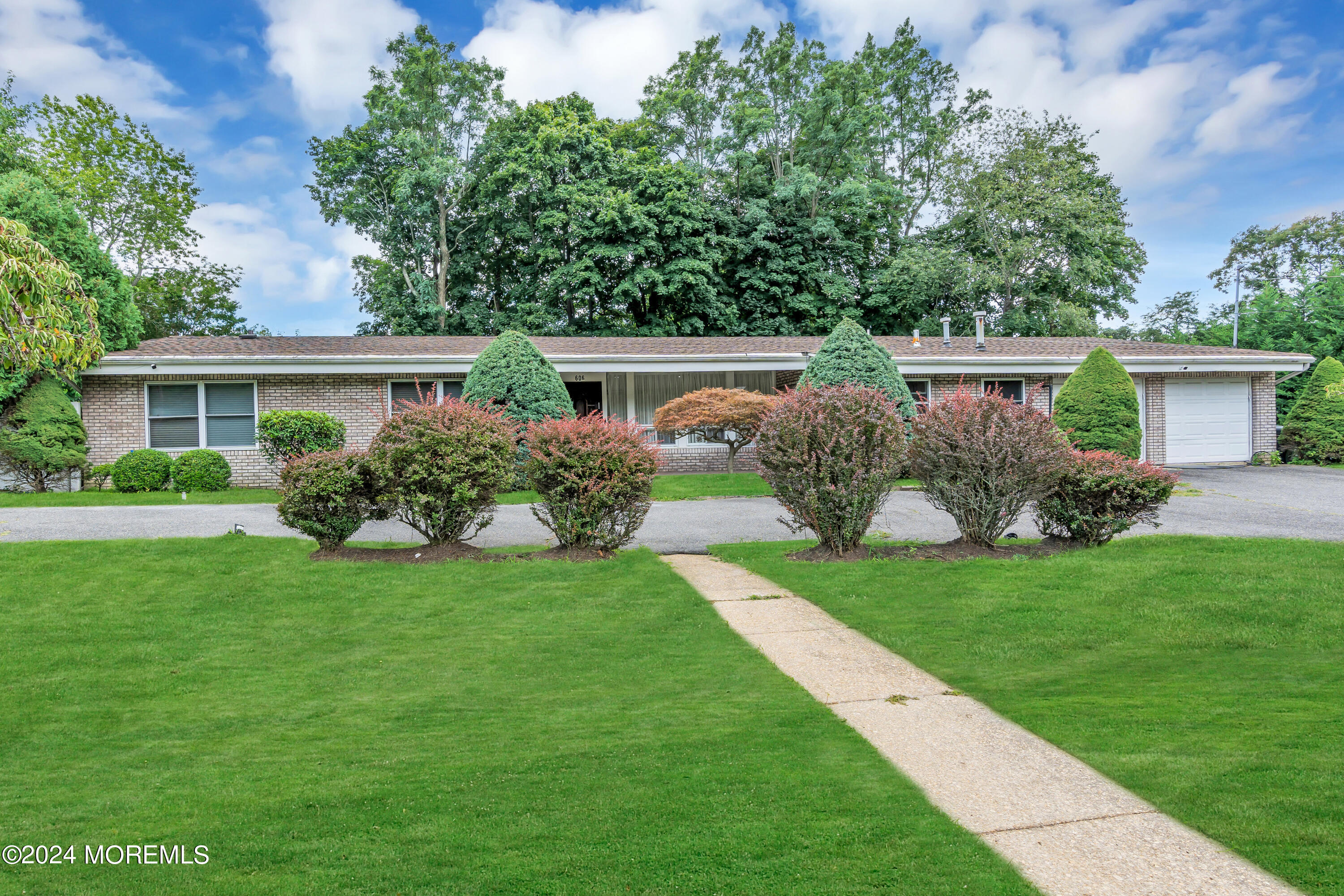 a front view of house with yard and green space