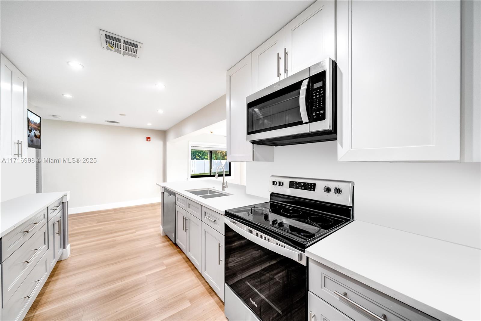 a kitchen with a stove and a microwave