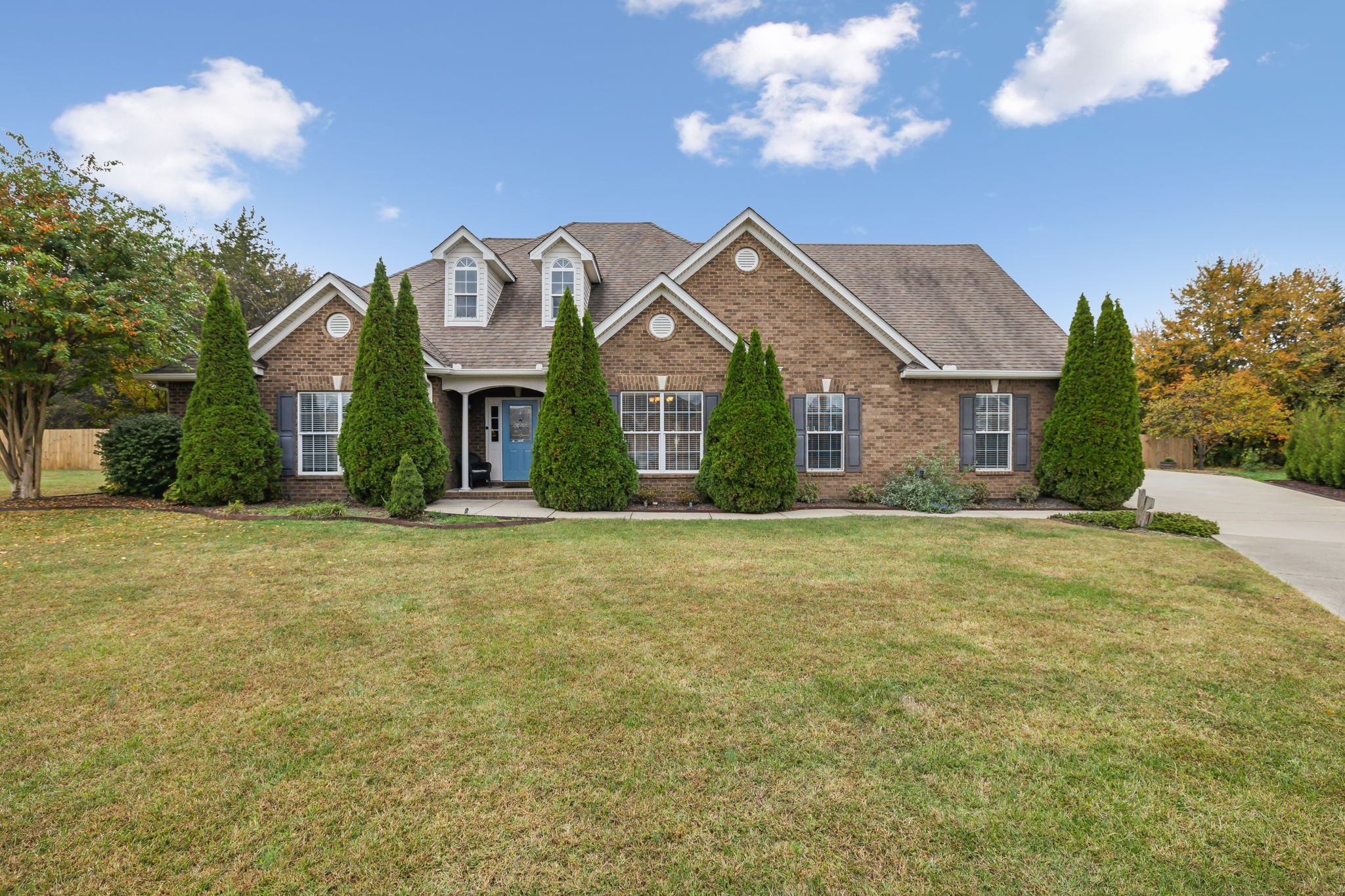 a front view of a house with a garden