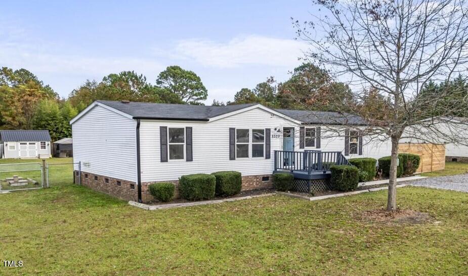 a front view of a house with a yard and trees