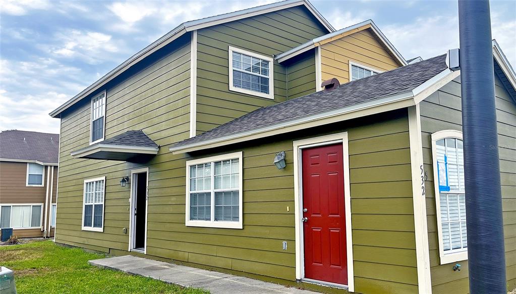 a front view of a house with a yard