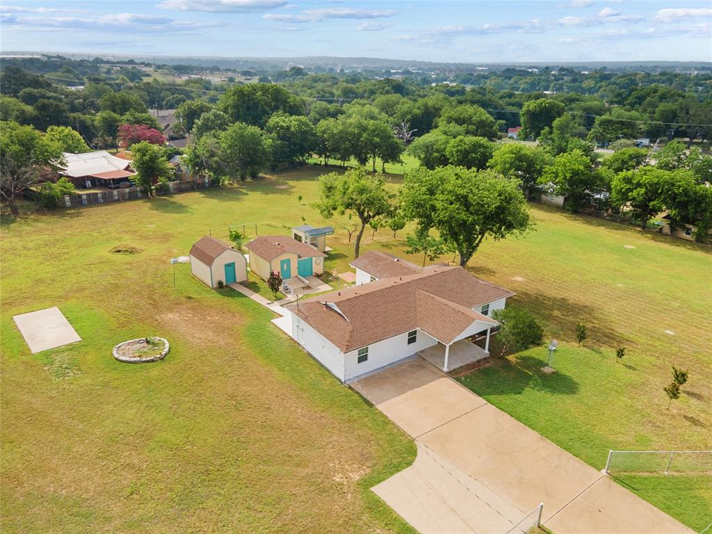 an aerial view of a house with a swimming pool yard and mountain view in back