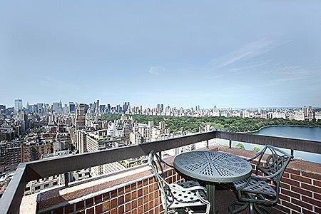 a view of a roof deck with a table and chair