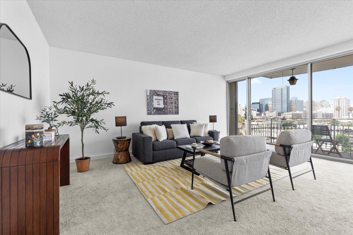 a living room with furniture and a floor to ceiling window