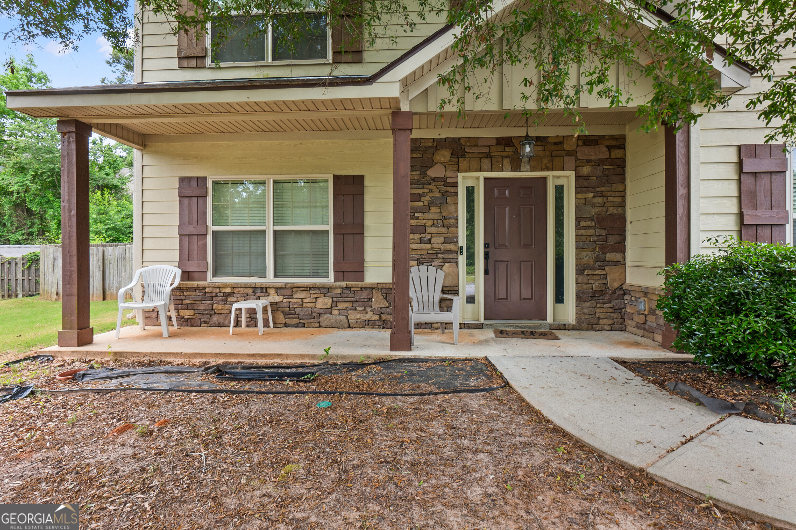 a front view of a house with large windows and a rug