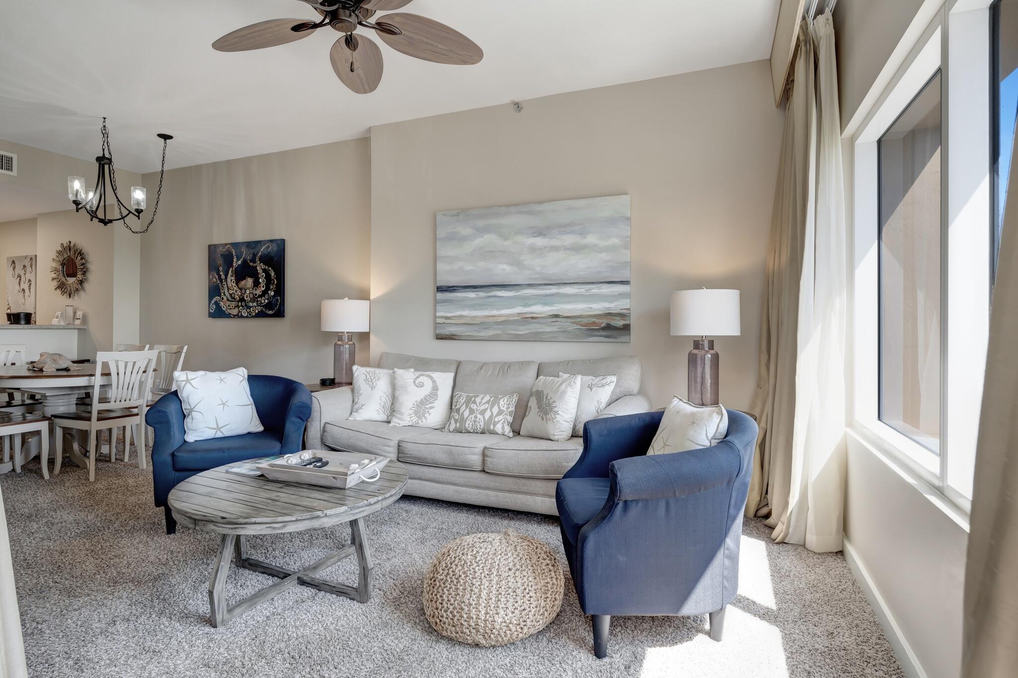 a living room with furniture a rug and a chandelier