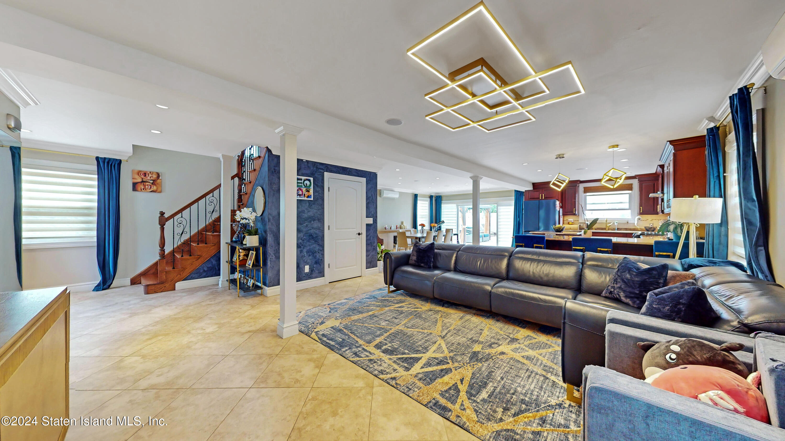 a living room with furniture and a gym