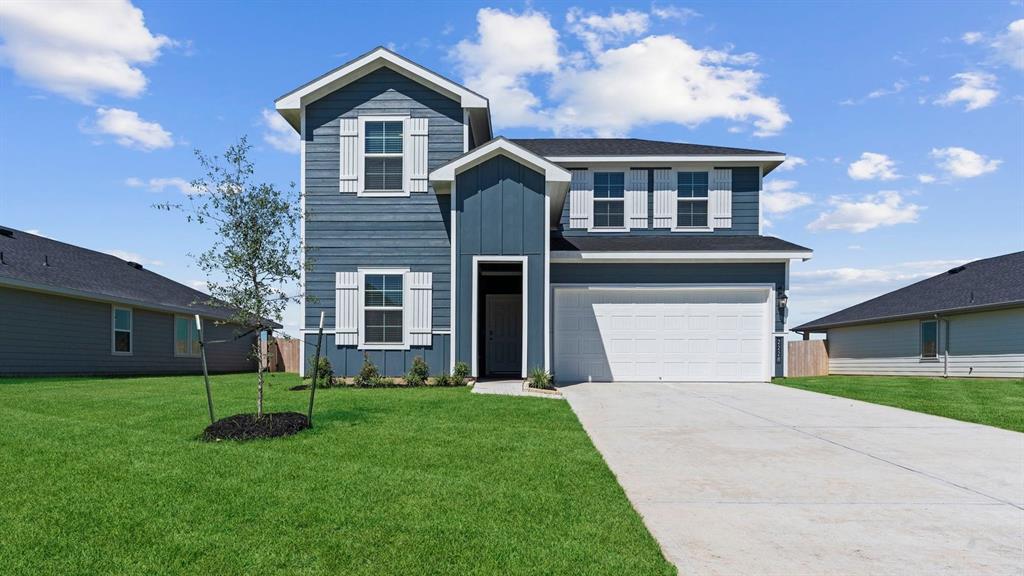 a front view of house with yard and green space