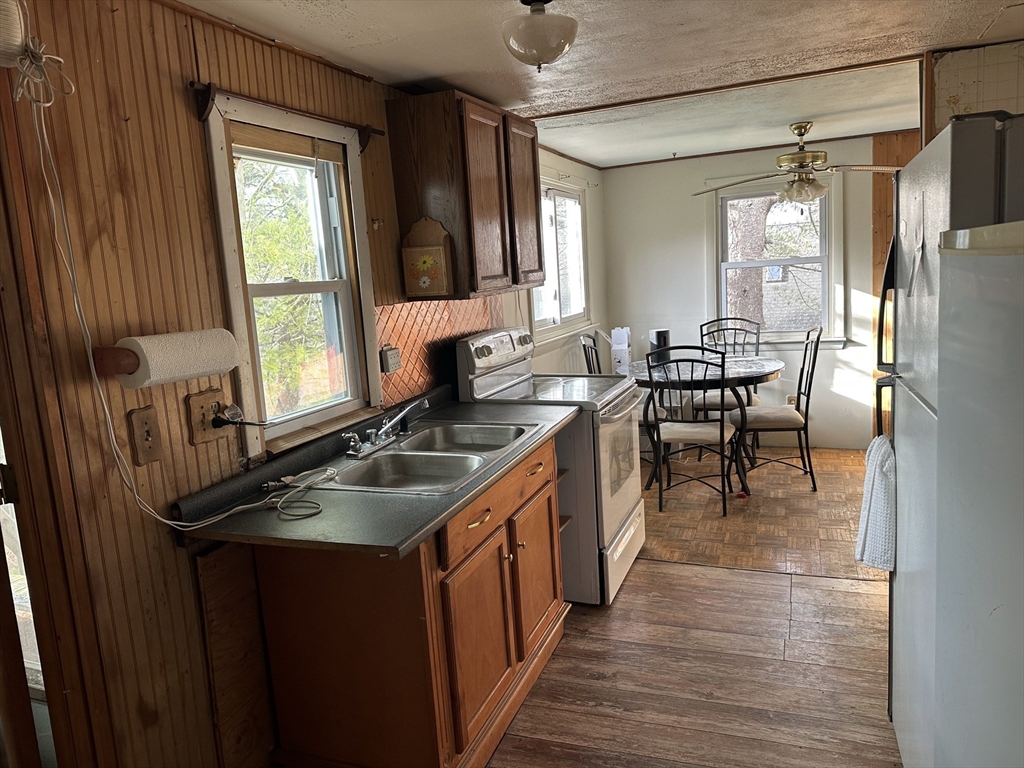 a kitchen with stainless steel appliances granite countertop sink stove top oven and cabinets