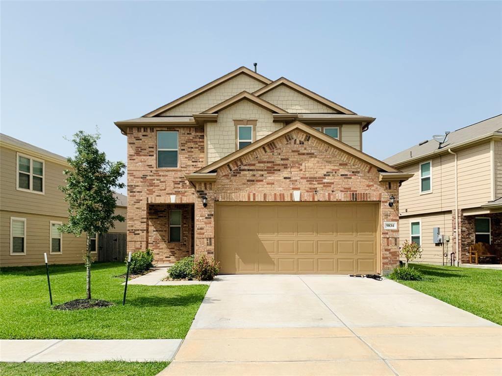 a front view of a house with a yard and garage