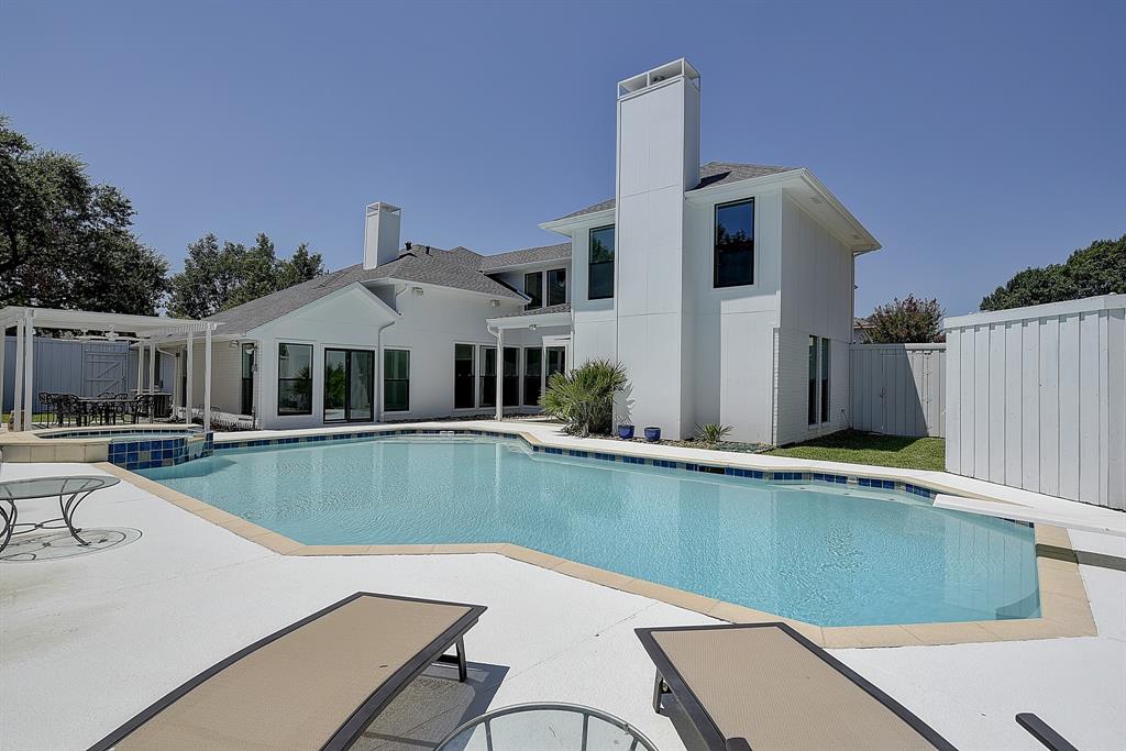 a view of a house with pool and chairs