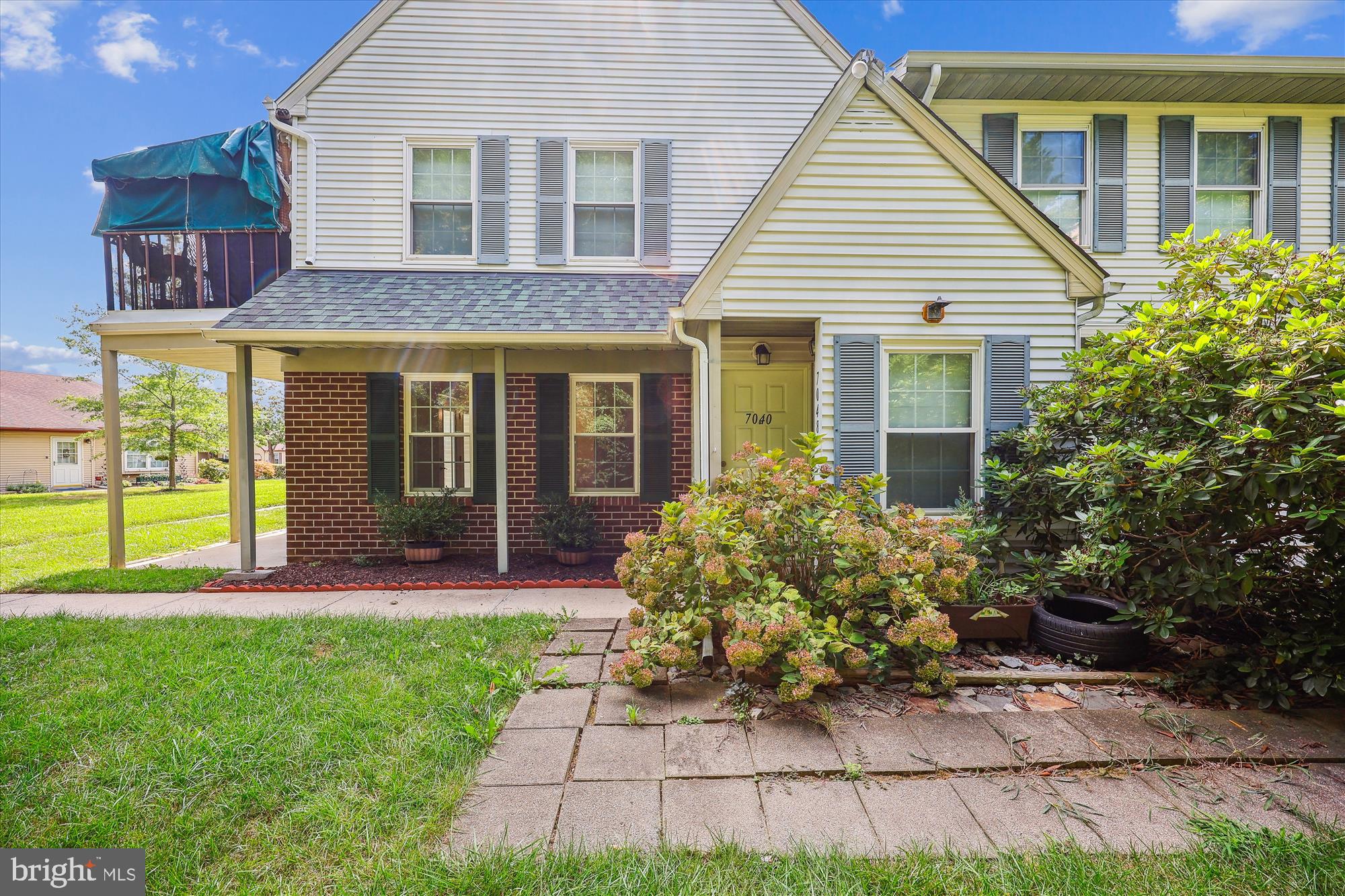 a front view of a house with a yard and porch