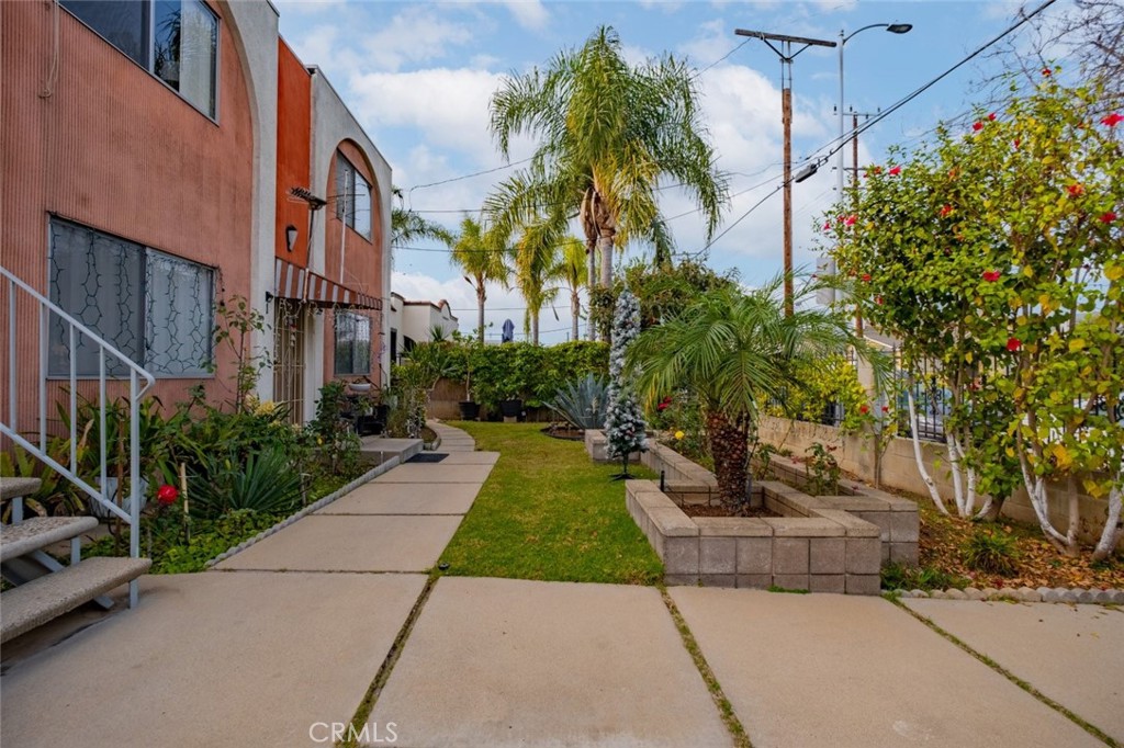 a view of backyard with plants and outdoor seating