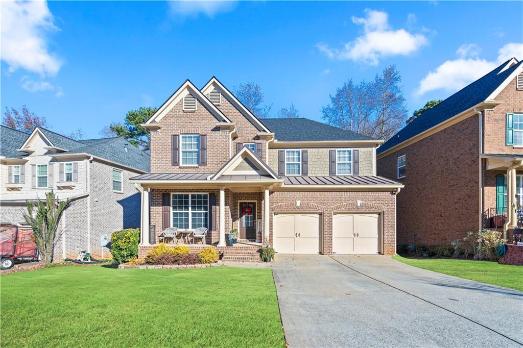 a front view of a house with a yard and garage