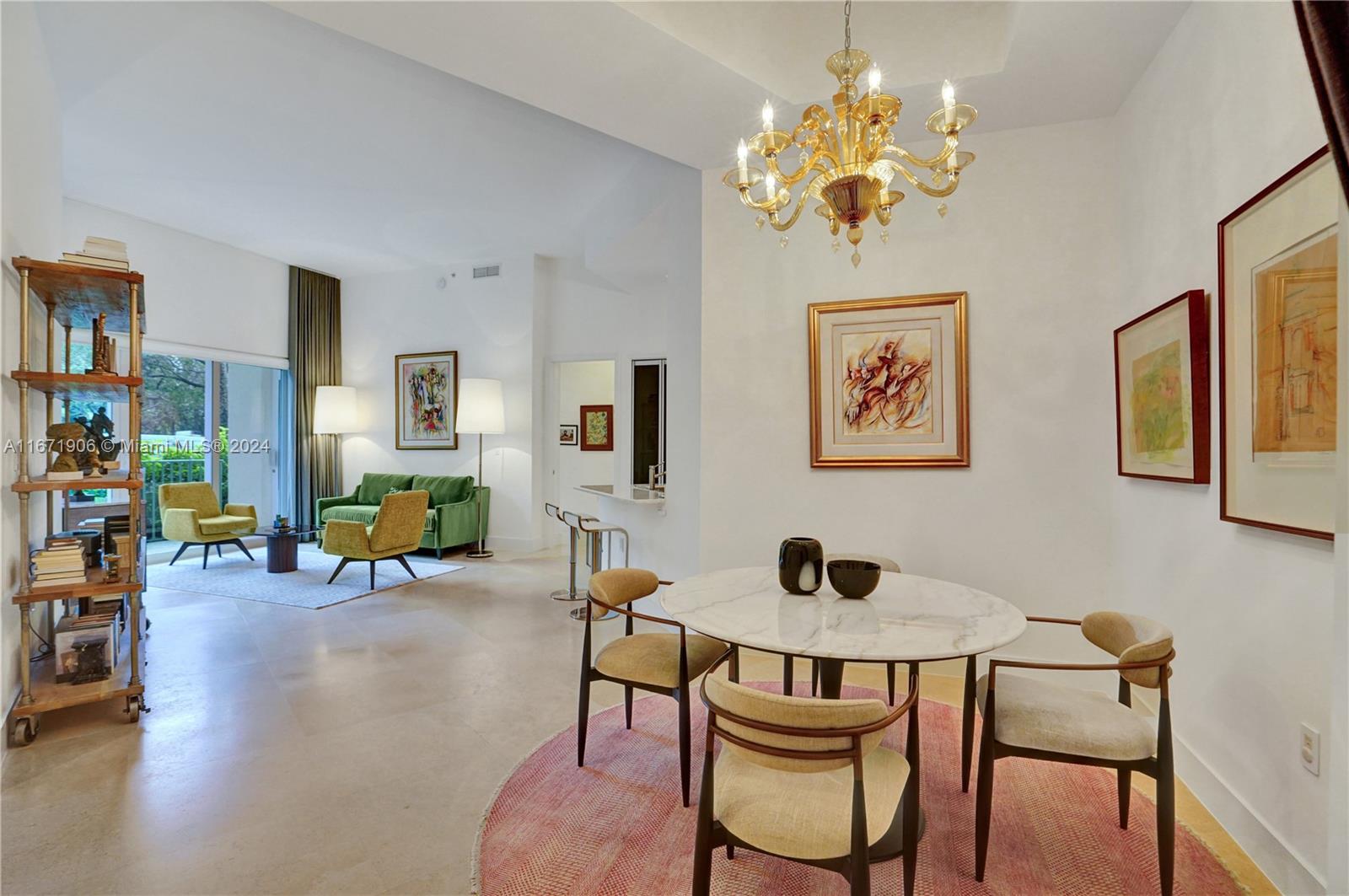 a view of a dining room with furniture and chandelier