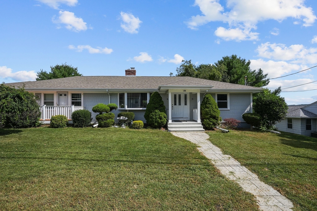 a front view of a house with a yard