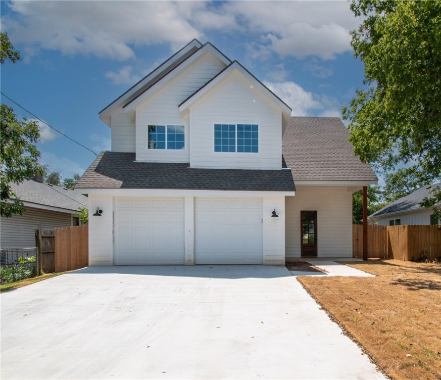 a view of a house with a yard and garage