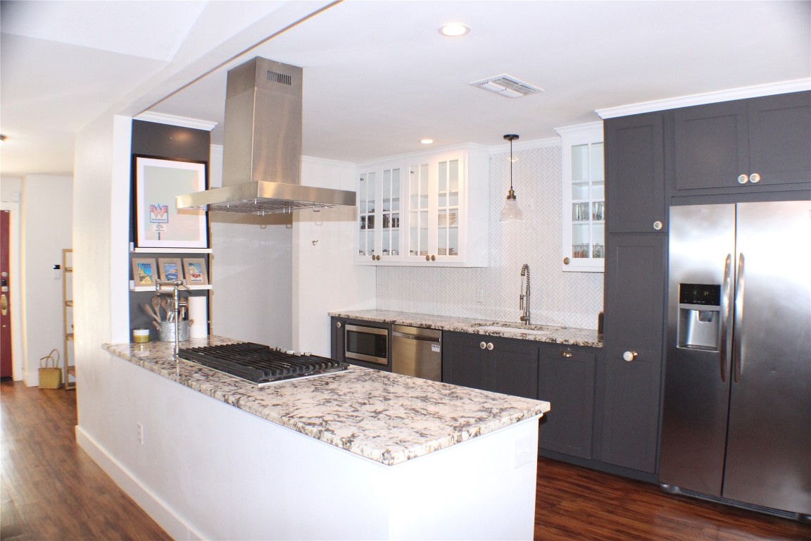 a kitchen with stainless steel appliances granite countertop a sink stove and refrigerator