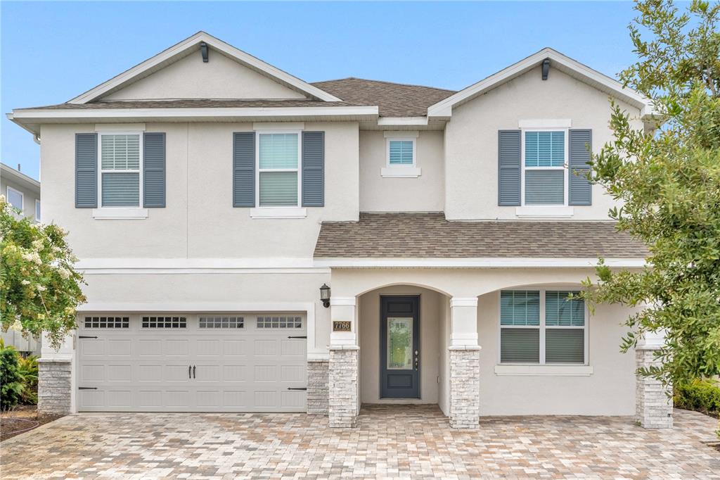 a front view of a house with a yard and garage