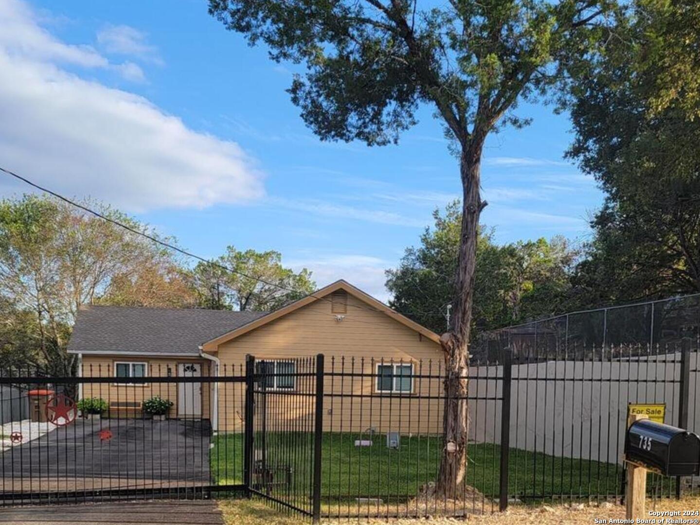 a view of a wrought iron fences in front of house