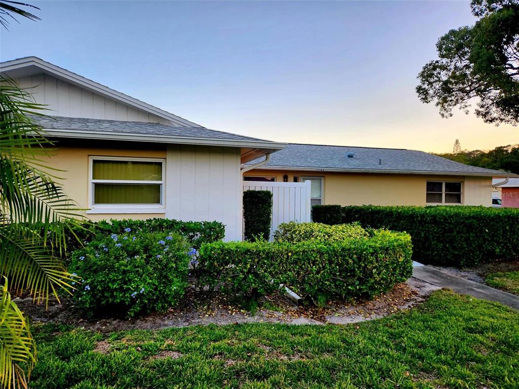 a front view of a house with a yard garage and outdoor seating