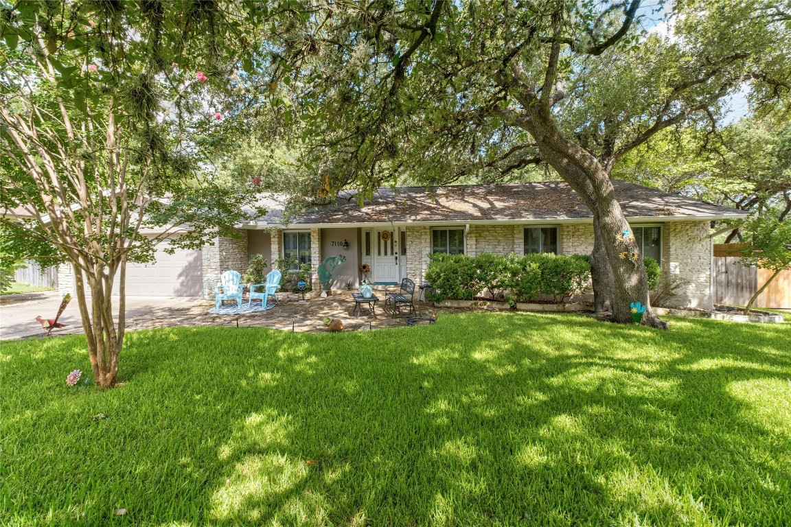 a front view of a house with yard patio and green space