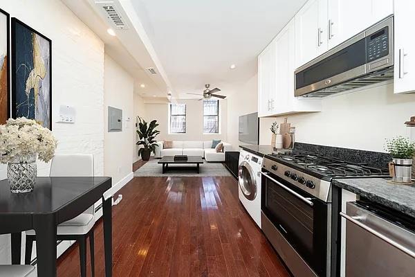 a kitchen with a stove a sink and a microwave