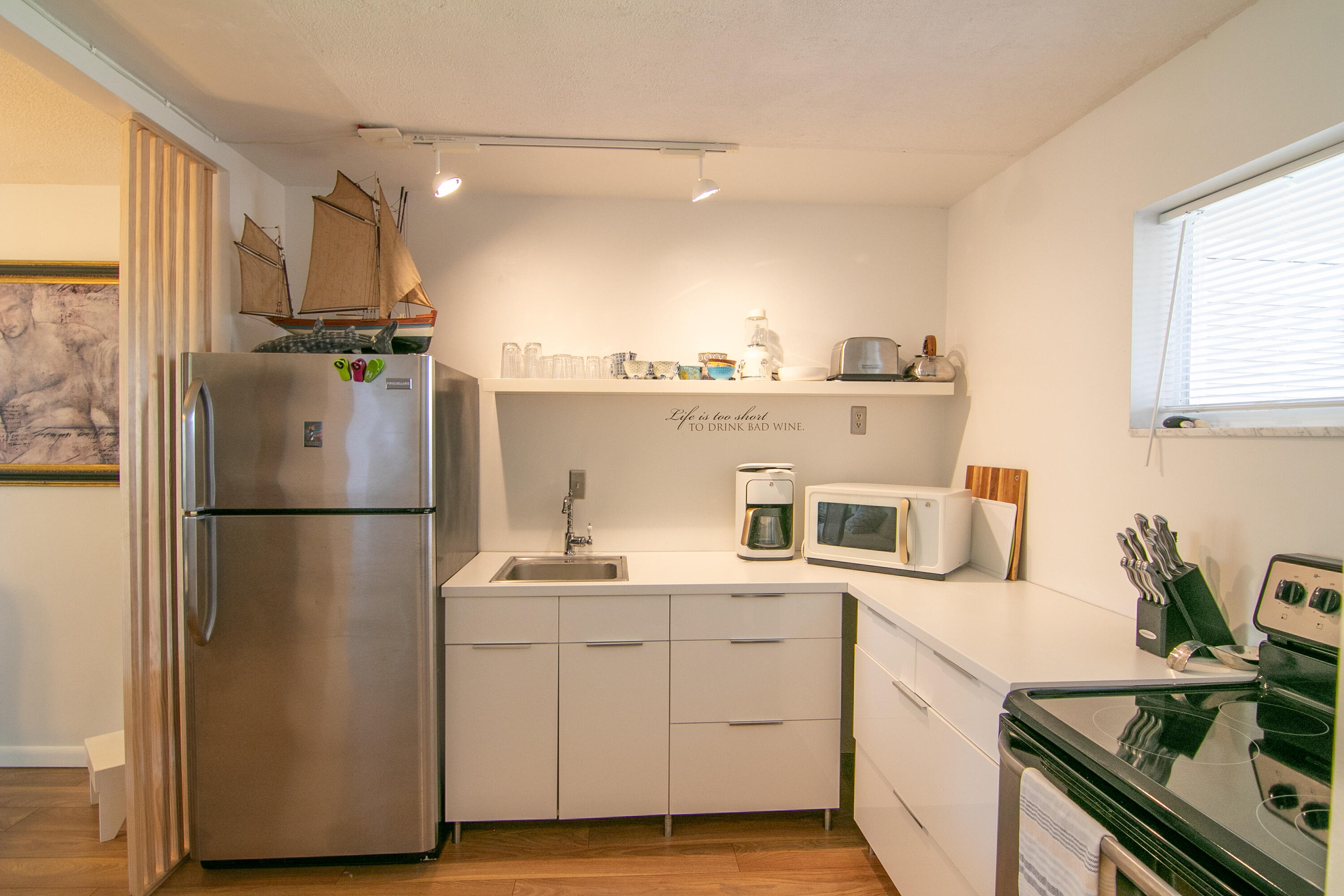 a kitchen with a refrigerator sink and cabinets