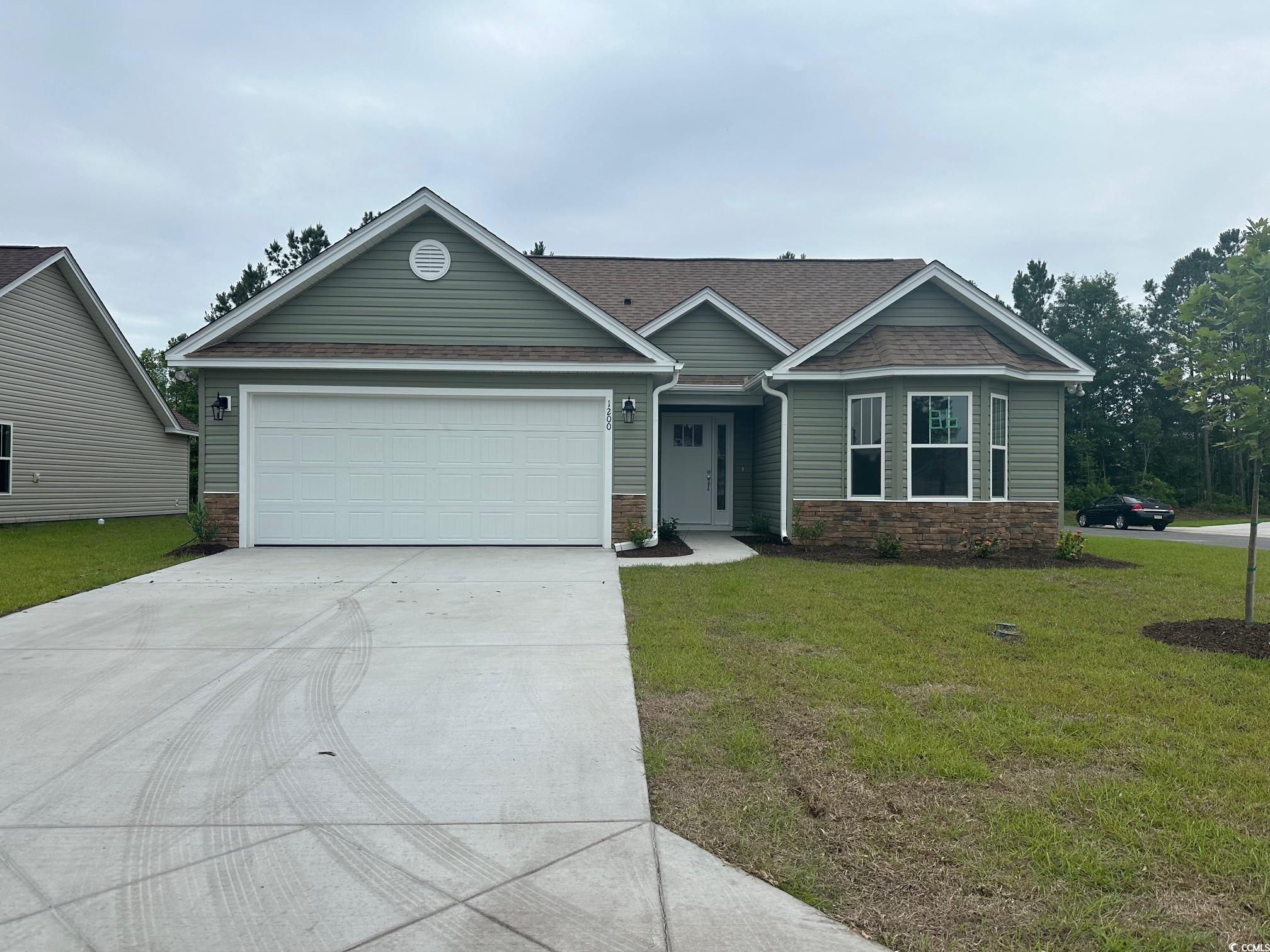 View of front of home featuring a garage and a fro