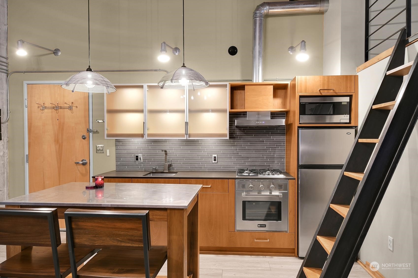 a kitchen with kitchen island a counter space and a sink