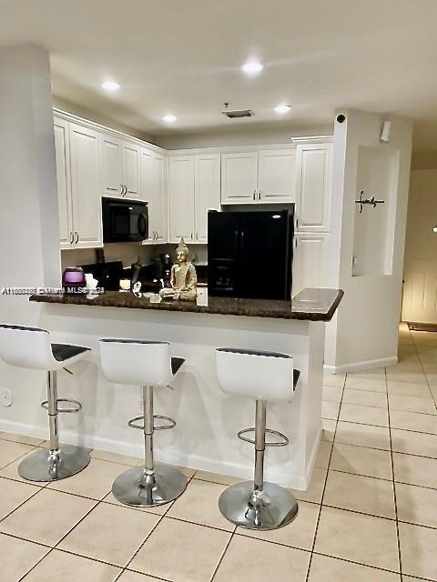 a kitchen with stainless steel appliances kitchen island granite countertop a sink and a cabinets