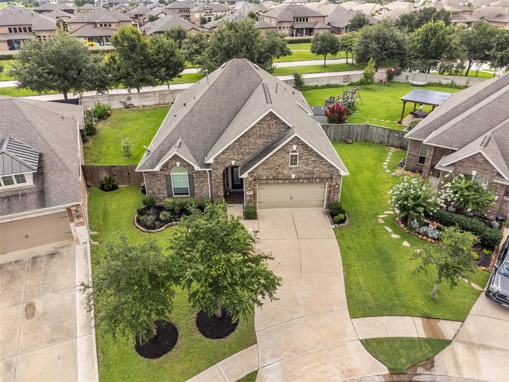 an aerial view of a house with a yard