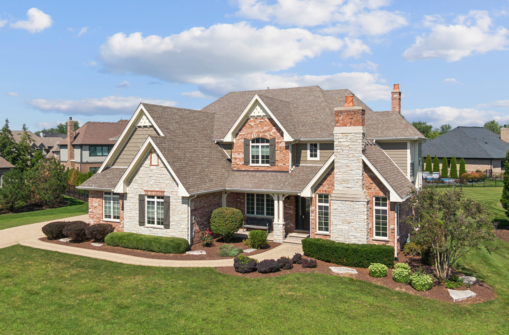 a front view of a house with a yard and porch