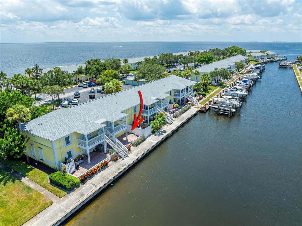 an aerial view of a house with a garden and lake view