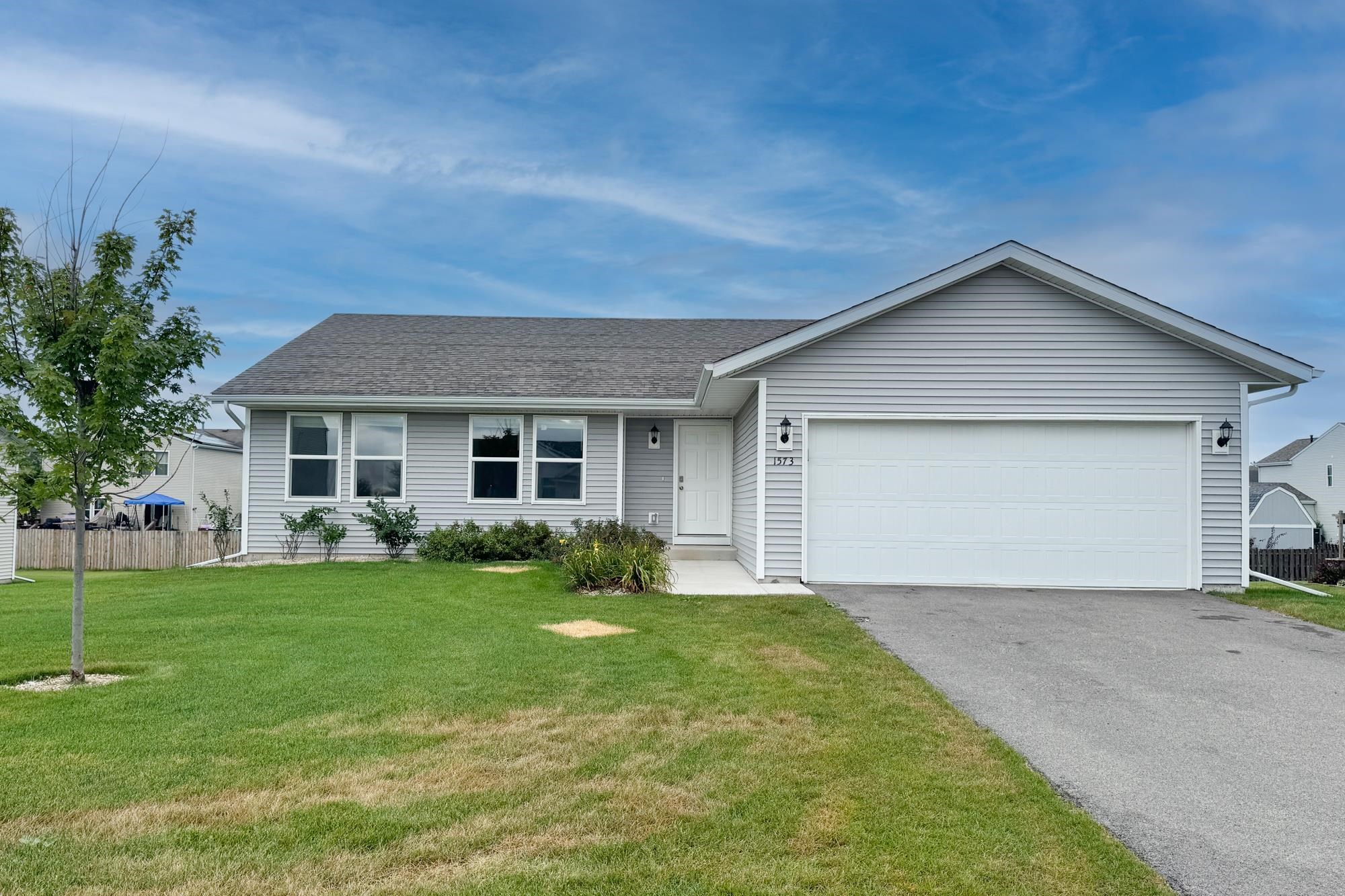 a front view of house with yard and green space