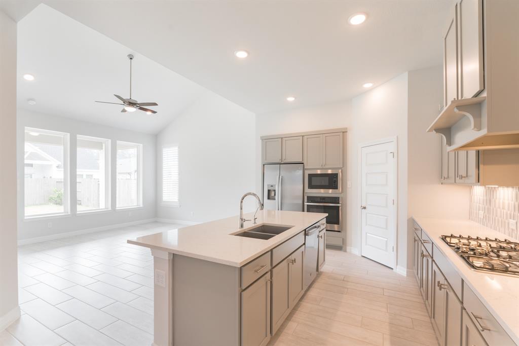 a kitchen with a sink stove and refrigerator