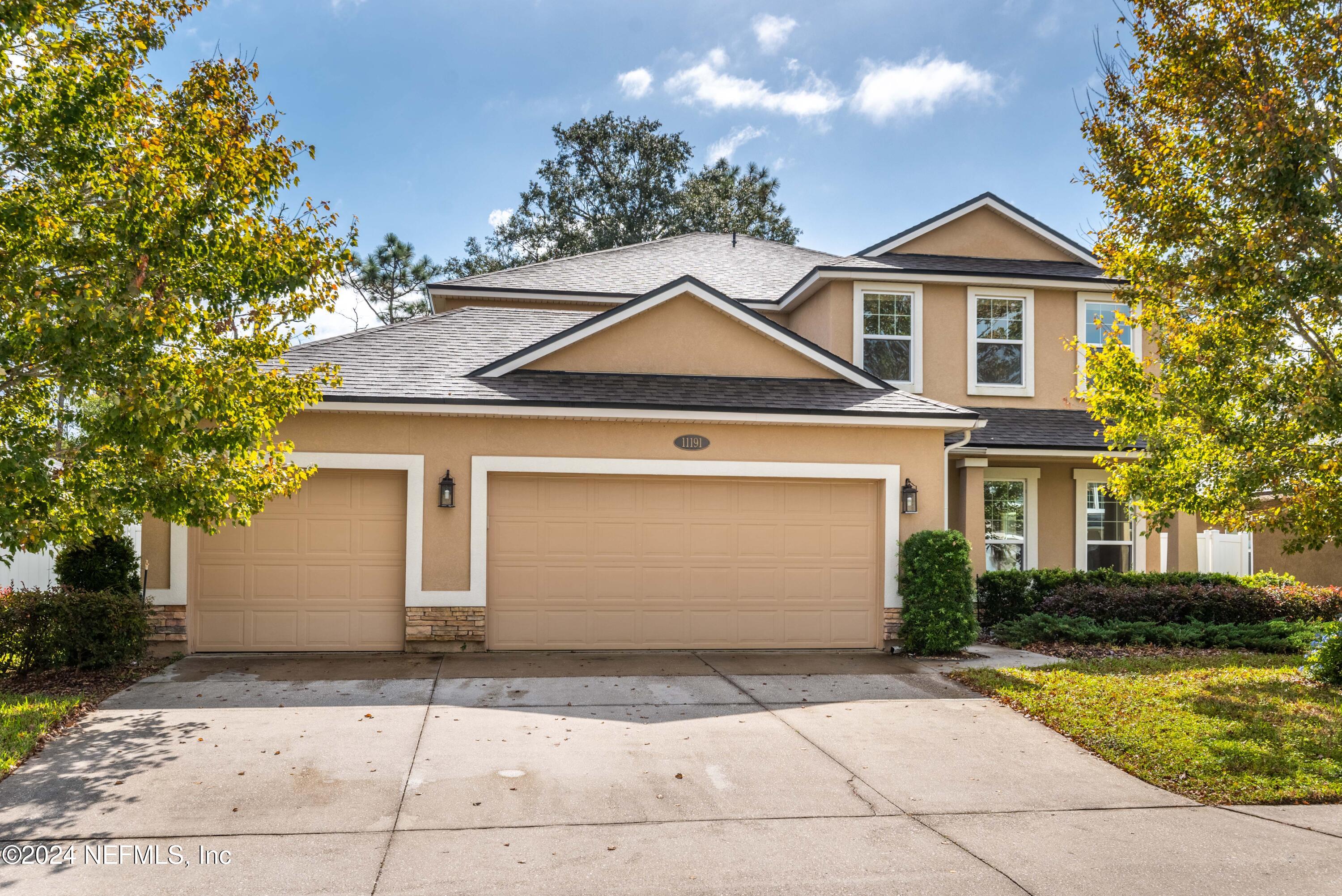 a front view of a house with a yard and garage