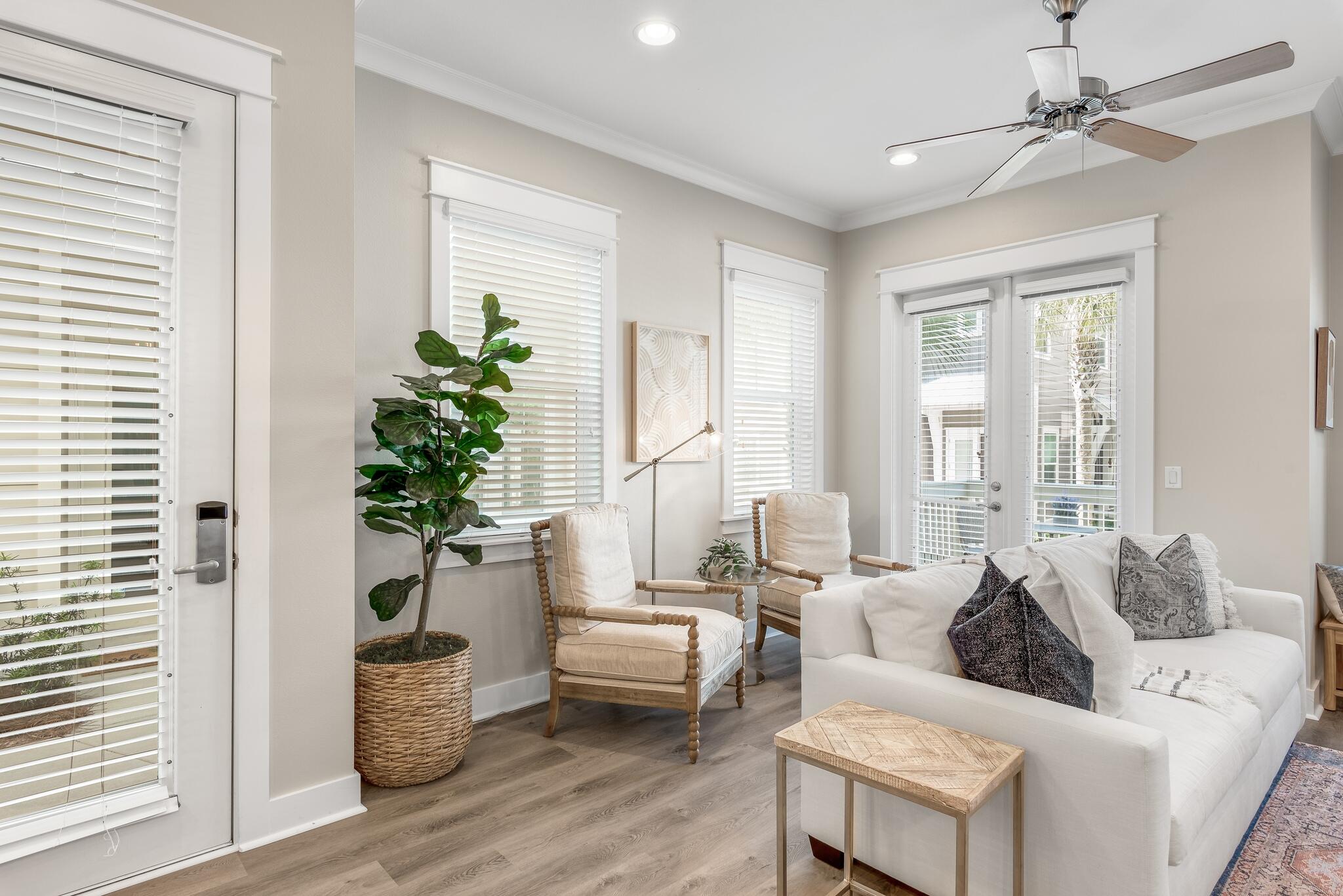 a living room with furniture and a potted plant