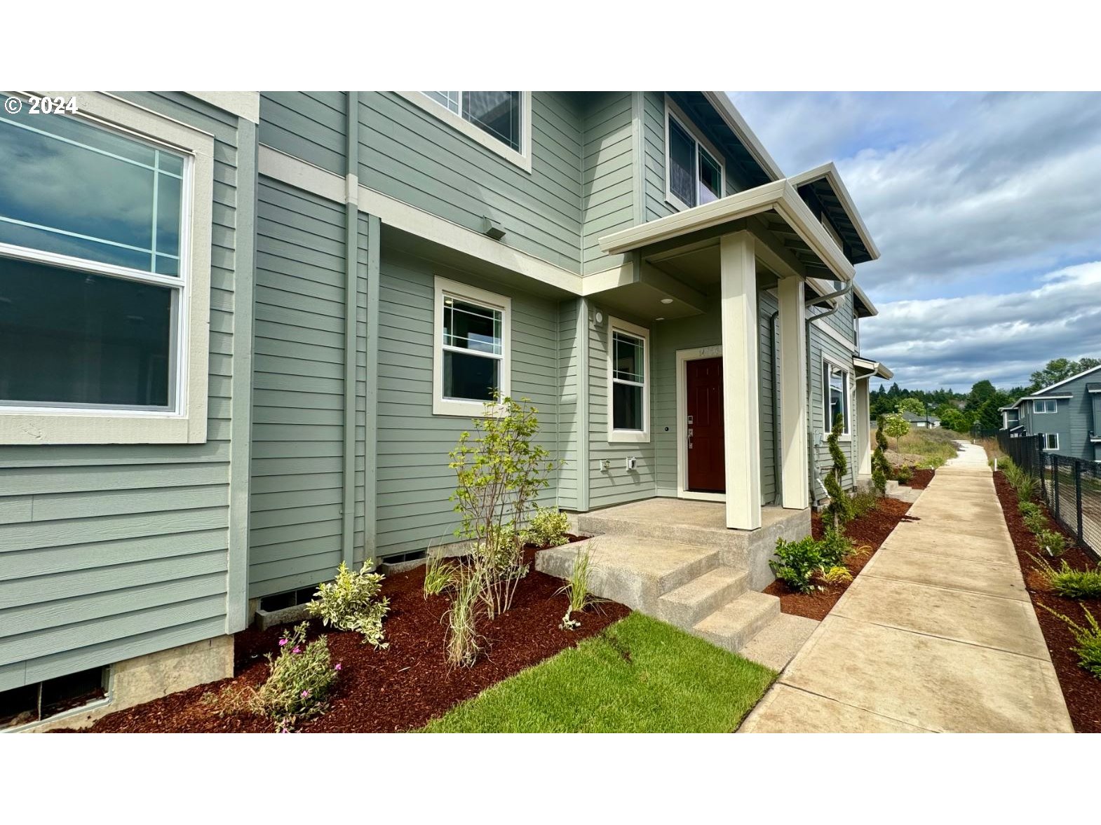 a view of house with backyard space and garden