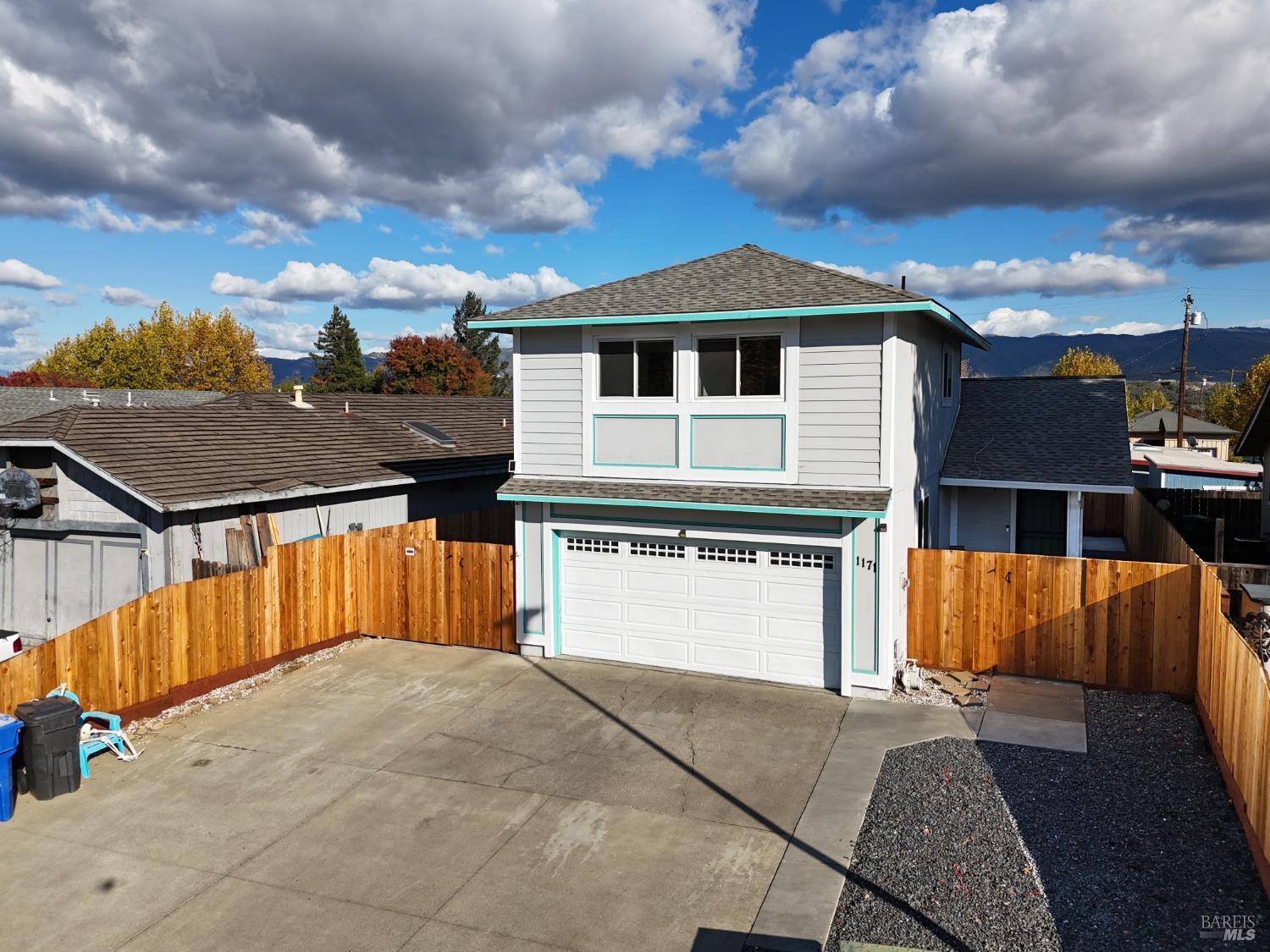 a view of a house with a backyard