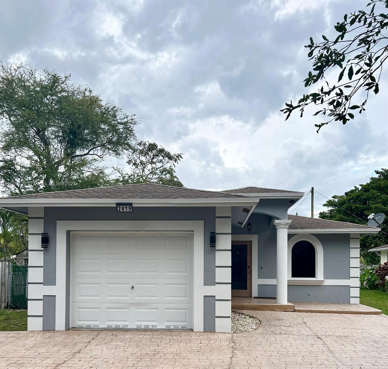 a front view of a house with a garage