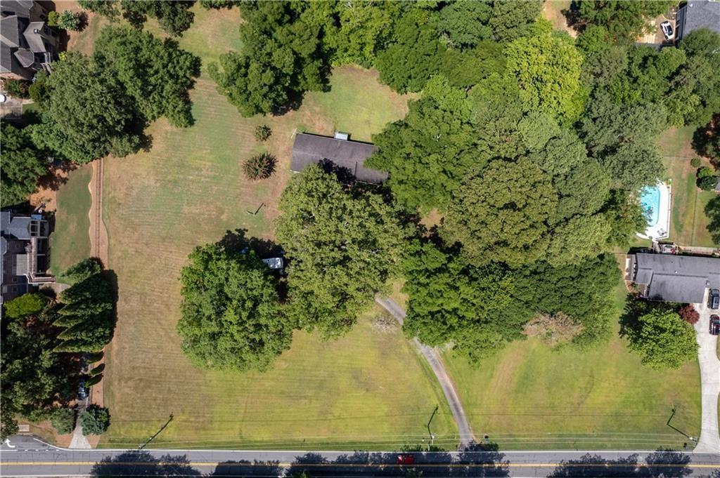 an aerial view of a house with a yard