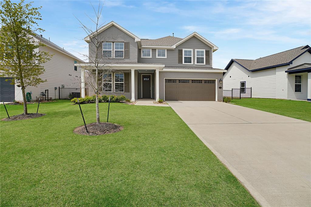 a front view of house with yard and green space